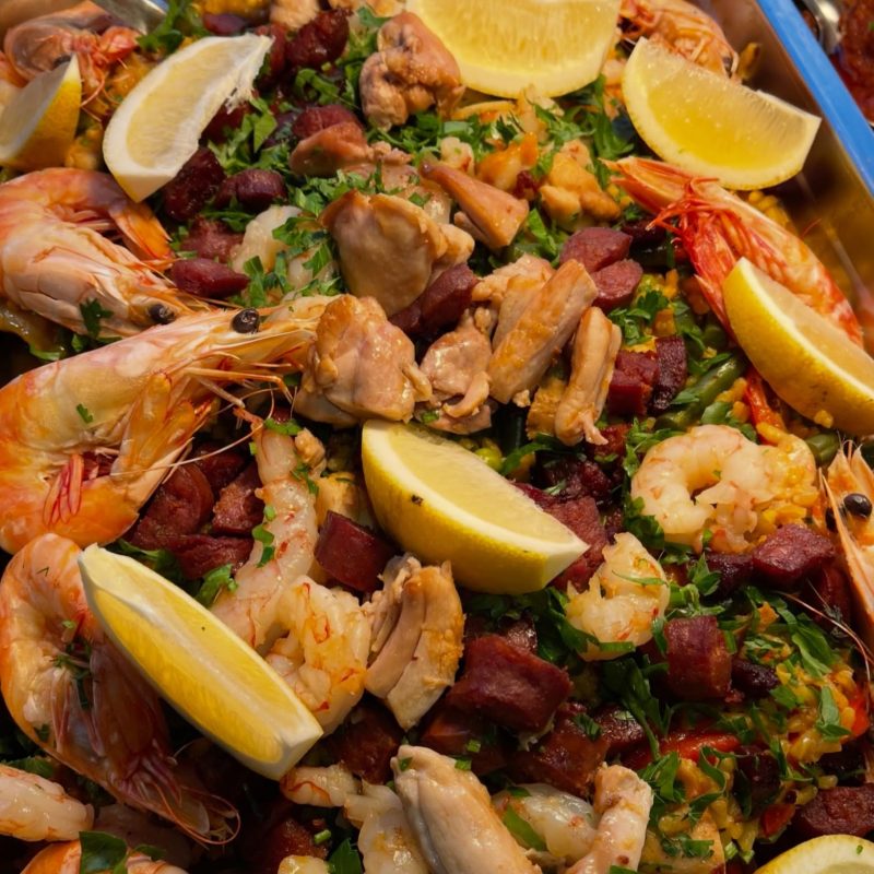 Paella with prawns, chicken and chorizo served in quantity